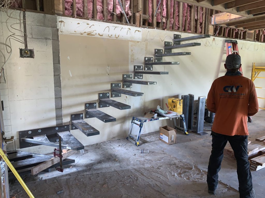 Welder working on stairs on a jobsite